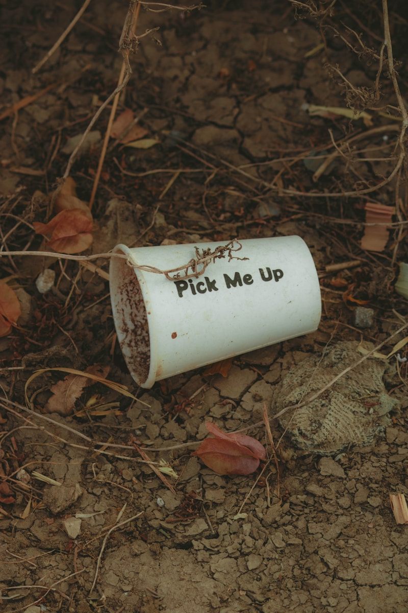 a white cup that says pick me up on the ground